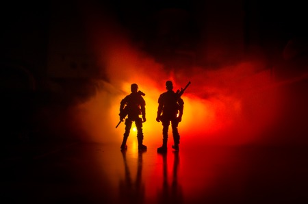 Anti-riot police give signal to be ready. Government power concept. Police in action. Smoke on a dark background with lights. Blue red flashing sirens. Dictatorship power. Selective focusの写真素材