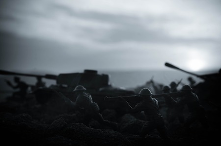 War Concept. Military silhouettes fighting scene on war fog sky background, World War Soldiers Silhouettes Below Cloudy Skyline At night. Attack scene. Armored vehicles. Tanks battle. Decorationの写真素材