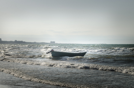 Beautiful landscape of Boat on the beach in cloudy weather. Vintage Boat in the seashore. Azerbaijan Caspian Seaの写真素材