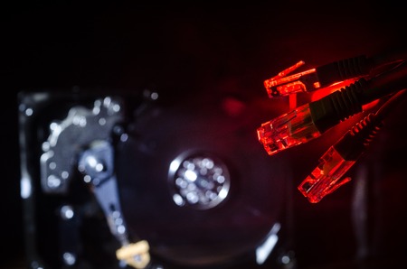 Network switch and ethernet cables, symbol of global communications. Colored network cables on dark background with lights and smoke. Selective focus. Network internet concept backgroundの写真素材