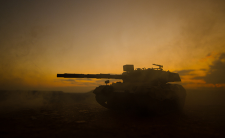 War Concept. Military silhouettes fighting scene on war fog sky background, World War German Tanks Silhouettes Below Cloudy Skyline At night. Attack scene. Armored vehicles. Tanks battleの写真素材