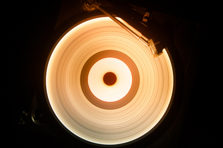 Concept of speed - Trail of fire and smoke - Vinyl record. Burning vinyl disk. Turntable vinyl record player. Retro audio equipment for disc jockey. Sound technologyの写真素材