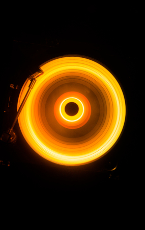 Concept of speed - Trail of fire and smoke - Vinyl record. Burning vinyl disk. Turntable vinyl record player. Retro audio equipment for disc jockey. Sound technologyの写真素材