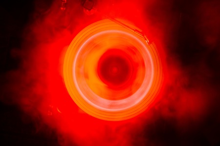 Concept of speed - Trail of fire and smoke - Vinyl record. Burning vinyl disk. Turntable vinyl...