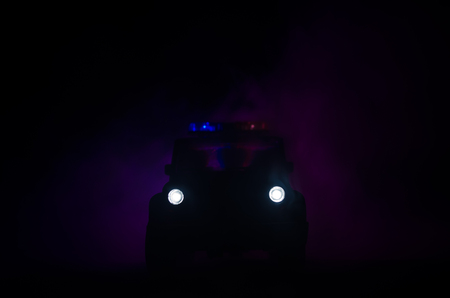 speed lighting of police car in the night on the road. Police cars on road moving with fog. Selective focusの写真素材