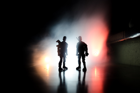 Anti-riot police give signal to be ready. Government power concept. Police in action. Smoke on a dark background with lights. Blue red flashing sirens. Dictatorship power. Selective focusの写真素材