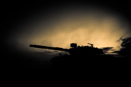 War Concept. Military silhouettes fighting scene on war fog sky background, World War German Tanks Silhouettes Below Cloudy Skyline At night. Attack scene. Armored vehicles. Tanks battleの写真素材