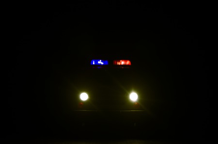 speed lighting of police car in the night on the road. Police cars on road moving with fog. Selective focusの写真素材