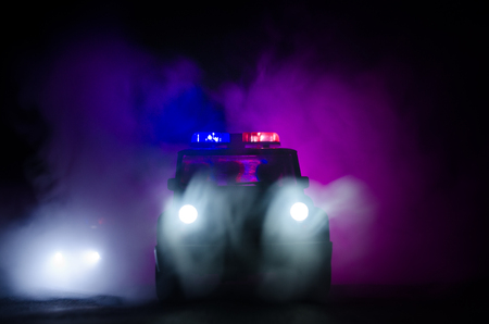speed lighting of police car in the night on the road. Police cars on road moving with fog. Selective focusの写真素材