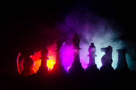 chess board game concept of business ideas and competition and strategy ideas concep. Chess figures on a dark background with smoke and fog. Selective focusの写真素材