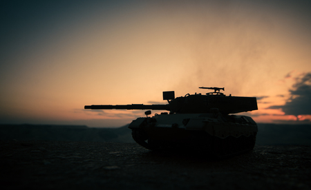 War Concept. Military silhouettes fighting scene on war fog sky background, World War German Tanks Silhouettes Below Cloudy Skyline At night. Attack scene. Armored vehicles. Tanks battleの写真素材