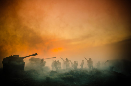 War Concept. Military silhouettes fighting scene on war fog sky background, World War Soldiers Silhouettes Below Cloudy Skyline At night. Attack scene. Armored vehicles. Tanks battle. Decorationの写真素材