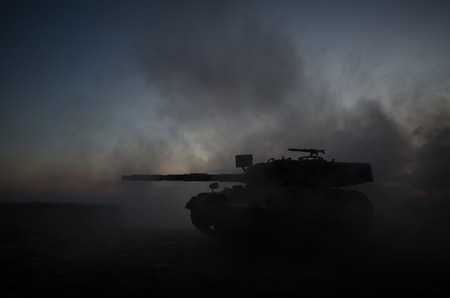 War Concept. Military silhouettes fighting scene on war fog sky background, World War German Tanks Silhouettes Below Cloudy Skyline At night. Attack scene. Armored vehicles. Tanks battleの写真素材