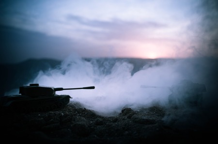 War Concept. Military silhouettes fighting scene on war fog sky background, World War Soldiers Silhouettes Below Cloudy Skyline At night. Attack scene. Armored vehicles. Tanks battle. Decorationの写真素材
