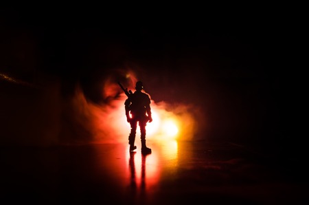 Anti-riot police give signal to be ready. Government power concept. Police in action. Smoke on a dark background with lights. Blue red flashing sirens. Dictatorship power. Selective focusの写真素材