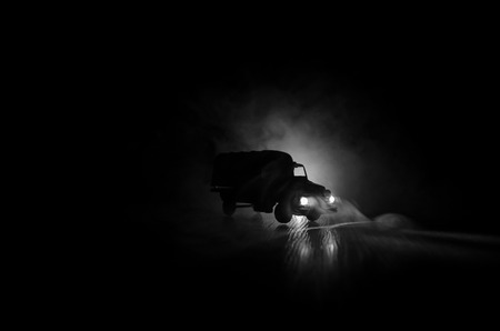 War Concept. Military silhouettes fighting scene on war fog sky background, World War Soldiers Silhouettes Below Cloudy Skyline At night. Attack scene. Armored vehicles. Trucks and army jeepの写真素材