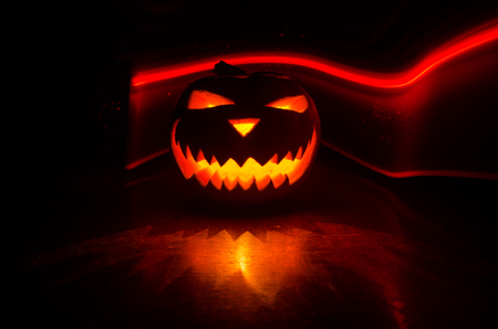 Halloween - old jack-o-lantern on black background. Spooky Halloween background with pumpkin - Happy Halloweenの写真素材