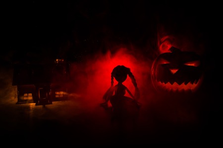Apocalyptic Halloween scenery with old house pumpkin. Horror zombie near the abandoned house