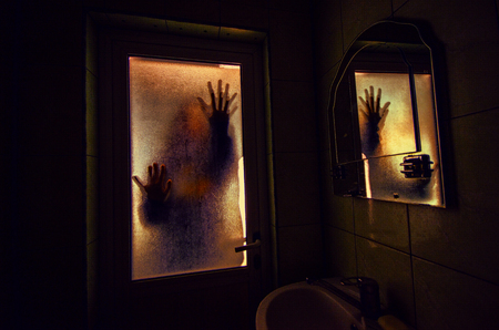 Horror woman in window wood hand hold cage scary scene halloween conceptの写真素材