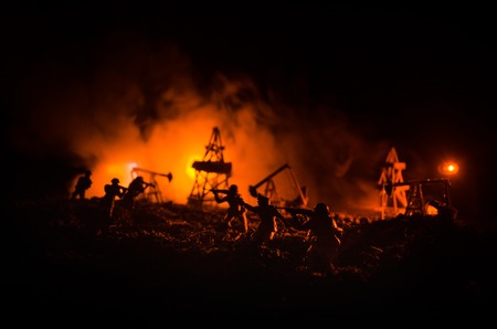 Silhouette of military soldier or officer with weapons. shot, holding gun, colorful sky, background. Oil war and military concept. Selective focusの写真素材