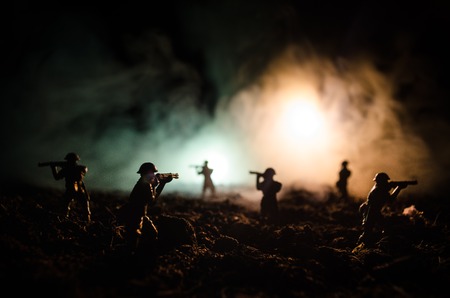 War Concept. Military silhouettes fighting scene on war fog sky background, World War Soldiers Silhouettes Below Cloudy Skyline At night. Attack scene. Armored vehicles. Tanks battle. Decorationの写真素材