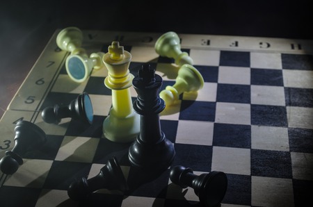 Chess board game concept of business ideas and competition and strategy ideas concep. Chess figures on a dark background with smoke and fog. Selective focusの写真素材