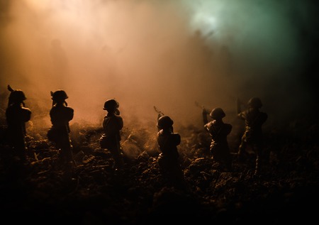War Concept. Military silhouettes fighting scene on war fog sky background, World War Soldiers Silhouettes Below Cloudy Skyline At night. Attack scene. Armored vehicles. Tanks battle. Decorationの写真素材
