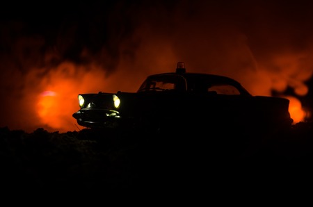 Silhouette of police car chasing a car at night with fog background. 911 Emergency response police...