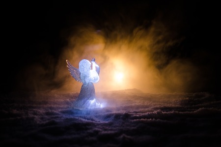 Christmas Angel glass xmas figure and glass fir tree, christmas tree, docorative elements on dark background. Christmas decoration angel xmas conceptの写真素材