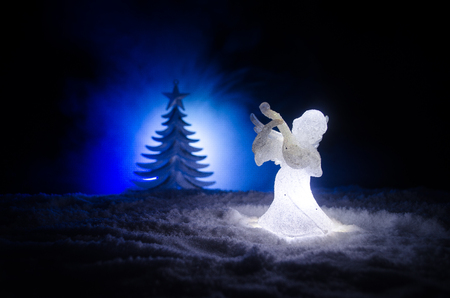 Christmas Angel glass xmas figure and glass fir tree, christmas tree, docorative elements on dark background. Christmas decoration angel xmas conceptの写真素材