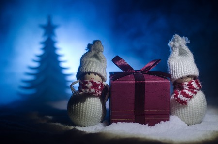 Happy Santa Claus Doll on Christmas time with tree and snow. Colorful bokeh background. Santa Clause...