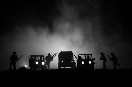 War Concept. Military silhouettes fighting scene on war fog sky backgroundの写真素材