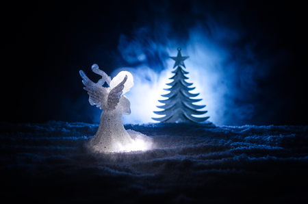 Christmas Angel glass xmas figure and glass fir tree, christmas tree, docorative elements on dark background. Christmas decoration angel xmas conceptの写真素材