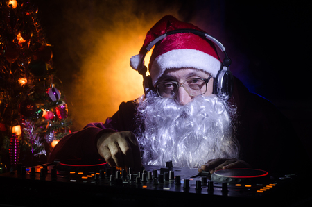 DJ Santa Claus mixing up some Christmas cheer. Dark disco club toned background. New Year's Eve...
