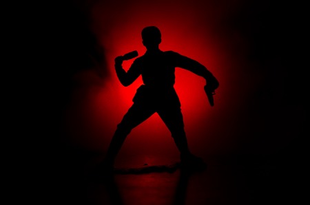 Military soldier silhouette with gun. War Concept. Military silhouettes fighting scene on war fog sky background, World War Soldier Silhouette Below Cloudy Skyline At night. Attack sceneの写真素材