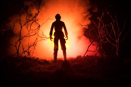 Military soldier silhouette with gun. War Concept. Military silhouettes fighting scene on war fog sky background, World War Soldier Silhouette Below Cloudy Skyline At night. Attack sceneの写真素材
