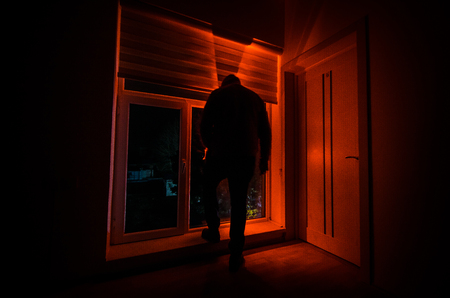 Horror man in window scary scene halloween concept Blurred silhouette of ghost. Horror theme. Selective focusの写真素材