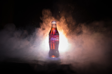 Baku, Azerbaijan 13th January 2018, Coca-Cola Classic in a glass bottle on dark toned foggy Background. Coca Cola, Coke is the most popular carbonated soft drink beverages sold around the worldのeditorial素材