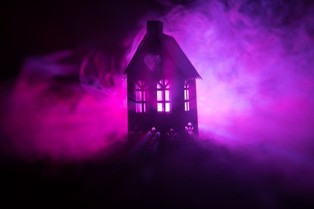 Black house with a heart and toned foggy sky in the background. Suitable for concepts such as Love...