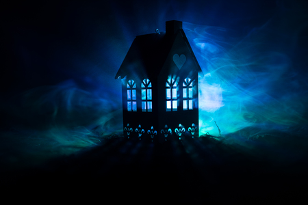 Black house with a heart and toned foggy sky in the background. Suitable for concepts such as Love house for Valentine`s Day. Selective focusの写真素材