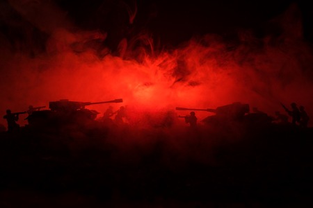 War Concept. Military silhouettes fighting scene on war fog sky background, World War Soldiers Silhouettes Below Cloudy Skyline At night. Attack scene. Armored vehicles. Tanks battle. Decorationの写真素材