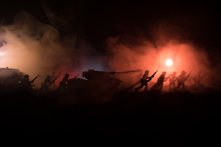 Military silhouettes fighting scene on war fog sky backgroundの写真素材