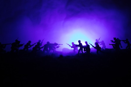 War Concept. Military silhouettes fighting scene on war fog sky backgroundの写真素材