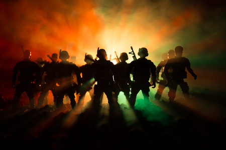 War Concept. Military silhouettes fighting scene on war fog sky backgroundの写真素材