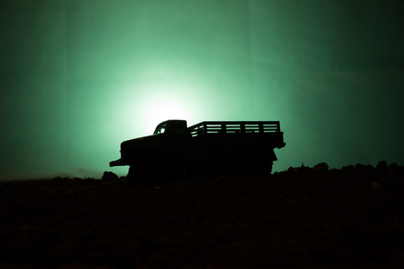 Military silhouettes fighting scene on war fog sky backgroundの写真素材