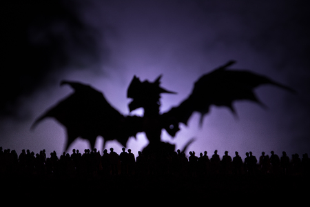 Blurred silhouette of giant monster prepare attack crowd during night. Selective focus.の写真素材