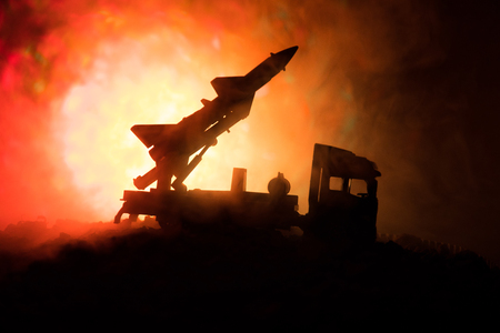 Rocket launch with fire clouds. Battle scene with rocket Missiles with Warhead Aimed at Gloomy Sky at night. Rocket vehicle on War Backgound. Selective focusの写真素材