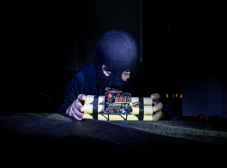 Terrorist making timebomb. terrorism and dangerous concept. Dark backgroundの写真素材