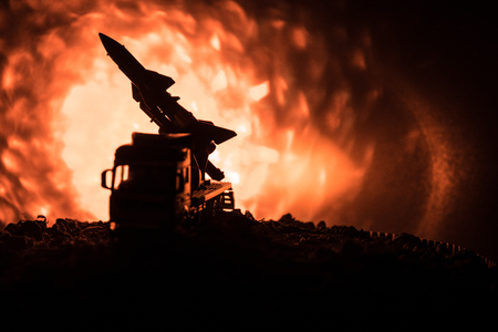 Rocket launch with fire clouds. Battle scene with rocket Missiles with Warhead Aimed at Gloomy Sky at night. Rocket vehicle on War Backgound. Selective focusの写真素材