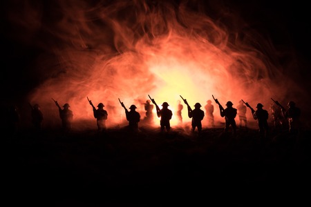 War Concept. Military silhouettes fighting scene on war fog sky background, World War Soldiers Silhouettes Below Cloudy Skyline At night. Attack scene. Armored vehicles. Tanks battle. Decorationの写真素材